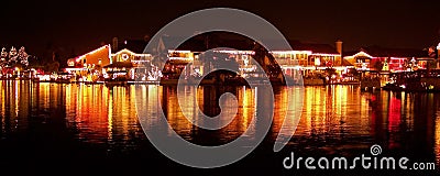 Christmas Lights of Houses Reflecting on Lake Stock Photo