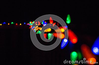 Christmas lights at night along a fence Stock Photo