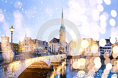 christmas lights and snow in Zurich city center with famous Fraumunster and Grossmunster Churches and river Limmat at Lake Zurich Stock Photo