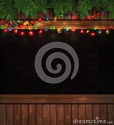 Christmas lights on wooden blackboard Stock Photo