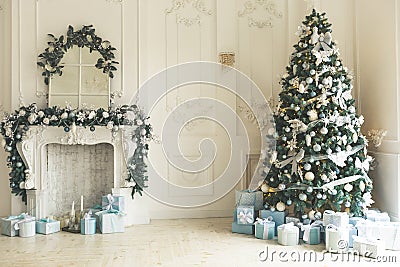 Christmas living room with a Christmas tree, fireplace, gifts and a large window. Beautiful New Year decorated classic home interi Stock Photo