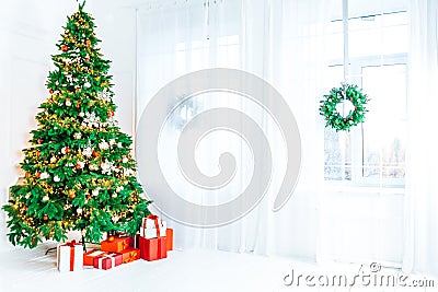 Christmas living room with a Christmas tree, gifts and a large window. Beautiful New Year decorated classic home interior Stock Photo