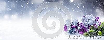 Christmas luxury purple gifts in snow and abstract snowy atmosphere Stock Photo