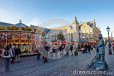 Christmas market, Dusseldorf, Germany with carrousel, street artist, Christmas stalls and Town Hall in background. Editorial Stock Photo