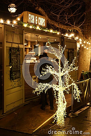 Christmas Market at Trafalgar Square with people gathered during night. Editorial Stock Photo