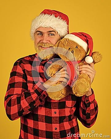 Christmas memories from childhood. Bearded man celebrate christmas. Kind hipster with teddy bear. Charity and kindness Stock Photo