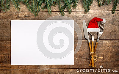 Christmas menu. Cutlery set on wooden table, top view with space for text. Christmas celebration. Seasonal background with Stock Photo