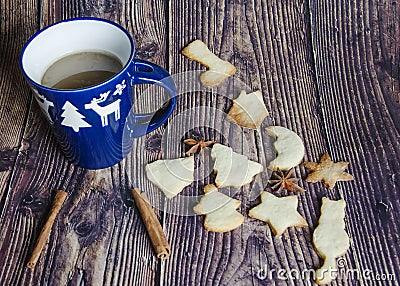 Christmas mood: a cup of hot coffee and handmade cookies. Served in a blue mug with white deer, cinnamon, anise Stock Photo