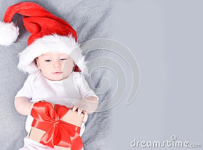 Christmas mood. Cute four month old baby in a red Santa Claus hat Stock Photo