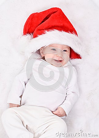 Christmas mood. Cute four month old caucasian baby in a Santa Claus hat Stock Photo
