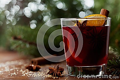 Christmas mulled wine or gluhwein with spices and orange slices on rustic table, traditional drink on winter holiday, magic light Stock Photo