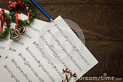 Christmas music note paper with Christmas wreath on wo Stock Photo