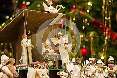 Christmas nativity scene with blurred Chrstmas tree in background Stock Photo