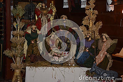 Christmas nativity scene - Jesus Christ, Mary and Joseph. Wooden figurines, donkey in the background Editorial Stock Photo