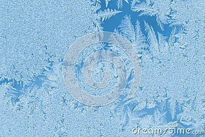 Christmas natural background in trendy color 2020 Classic Blue. Winter frosty pattern bizarre form on window glass. Stock Photo