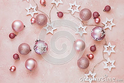 Shiny baubles and string on rustic pink background Stock Photo