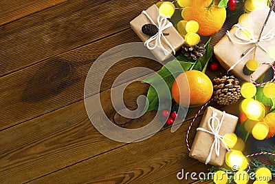 Christmas new year banner with tangerines, gift boxes pine cones, winter decorations over wooden background with copy space Stock Photo