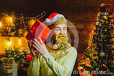 Christmas or New Year barber shop concept. Beard with bauble. Santa in barbershop. Christmas style for modern Santa. Stock Photo