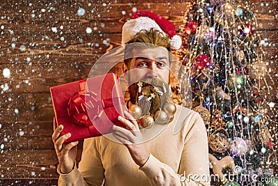 Christmas man in snow. Christmas or New Year barber shop concept. Beard with bauble. Santa in barbershop. Christmas Stock Photo