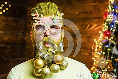 Christmas or New Year barber shop concept. Beard with bauble. Santa Hipster is funny. Stock Photo