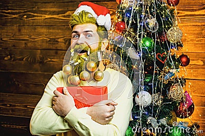 Christmas or New Year barbershop concept. Beard with bauble. Santa in barber shop. Christmas style for modern Santa. Stock Photo