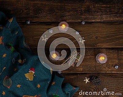 Christmas and New Year with candles, golden stars and green textile decoration, dark background Stock Photo