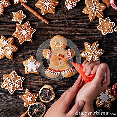 Woman decorating Christmas gingerbread man cookie Stock Photo