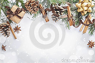 Christmas and New Year composition. Gift box with ribbon, fir branches with cones, star anise, cinnamon on white background Stock Photo