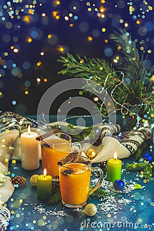 Christmas and New Year composition. Two cup of hot spicy tea with sea buckthorn, cinnamon and star anise, branches of pine and Stock Photo