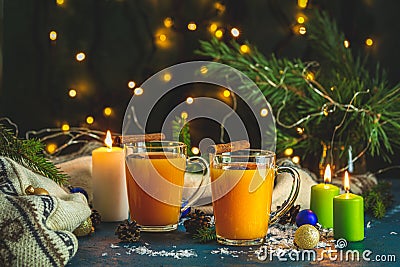 Christmas and New Year composition. Two cup of hot spicy tea with sea buckthorn, cinnamon and star anise, branches of pine and Stock Photo