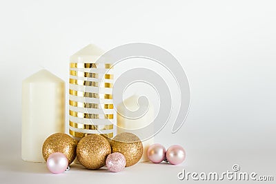 Christmas, New Year composition with candles, golden and pink baubles, balls on white backgound Stock Photo