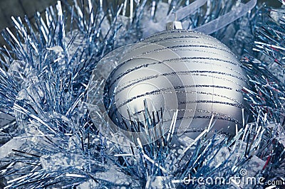 Christmas New Year decorations: blue foil, siver ball. Stock Photo