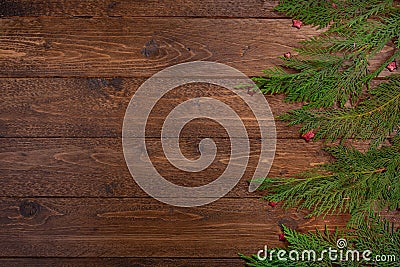 Christmas or New Year flat lay decoration background: cypress branches and small red stars, on dark wooden background Stock Photo