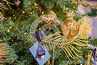 Christmas and New Year holidays background. Christmas tree decorated with gold ball and sparkling feather. Celebration concept Stock Photo