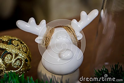 Christmas and New Year photo studio, green tree, ceramic figurine, white wall. Stock Photo