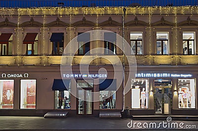 Christmas and New Year`s decorations in a Omega, Tommy Hilfiger, Intimissimi storefront. Editorial Stock Photo