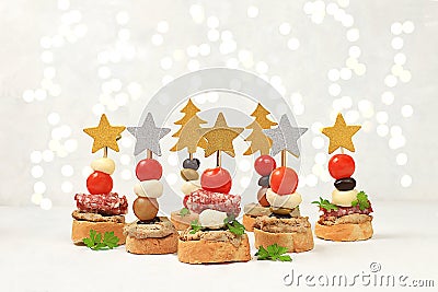 Christmas and New Year's dishes, a set of snacks for the festive table. Canapes of tomatoes, pate, mozzarella cheese, Stock Photo