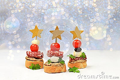 Christmas and New Year's dishes, a set of snacks for the festive table. Canapes of tomatoes, pate, mozzarella cheese, Stock Photo