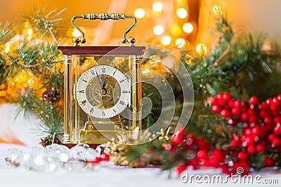 Christmas and New Year's still-life with a with a clock, red berries and spruce branches Stock Photo