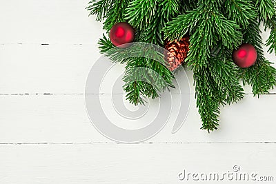 Christmas new Years background in retro vintage style with fresh fluffy fir tree branches red ornament balls on white plank wood Stock Photo