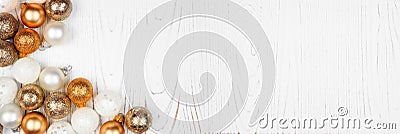 Christmas or New Years corner border of gold and white decorations on a white wood banner background Stock Photo