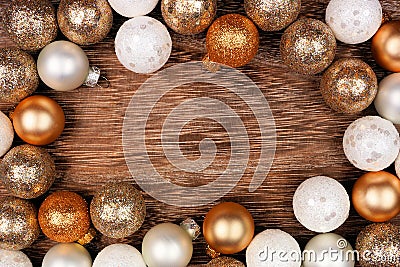 Christmas or New Years frame of gold and white decorations on a dark rustic wood background Stock Photo