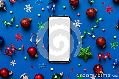 Christmas online shopping from home phone with blank white display top view. smart mobile with copy space on colored Stock Photo