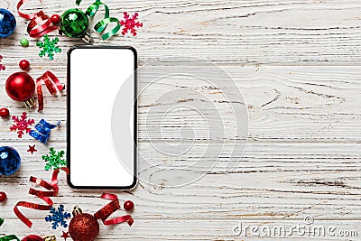 Christmas online shopping from home phone with blank white display top view. smart mobile with copy space on colored Stock Photo