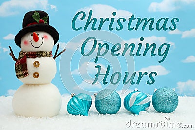 Christmas Opening Hours message with snowman, ornaments, and snow with sky Stock Photo