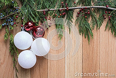 Christmas ornaments on hard wood background with green top frame Stock Photo