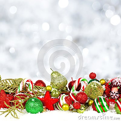 Christmas ornaments in snow with twinkling background Stock Photo