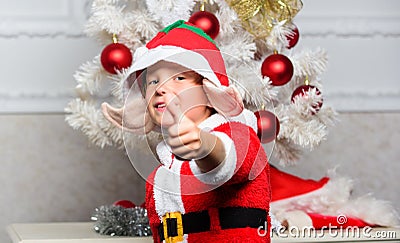 Christmas party with elf costume. Christmas tree ideas for kids. Boy kid dressed as cute elf magical creature white Stock Photo