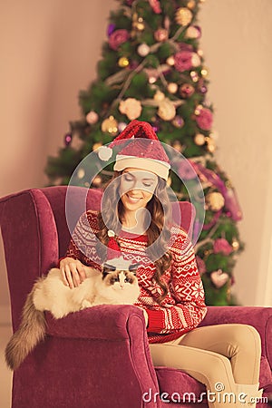 Christmas party, winter holidays woman with cat. New year girl. christmas tree in interior Stock Photo