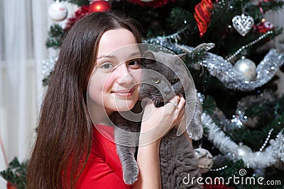 Christmas party, winter holidays woman with cat. New year girl. christmas tree in interior background. Stock Photo